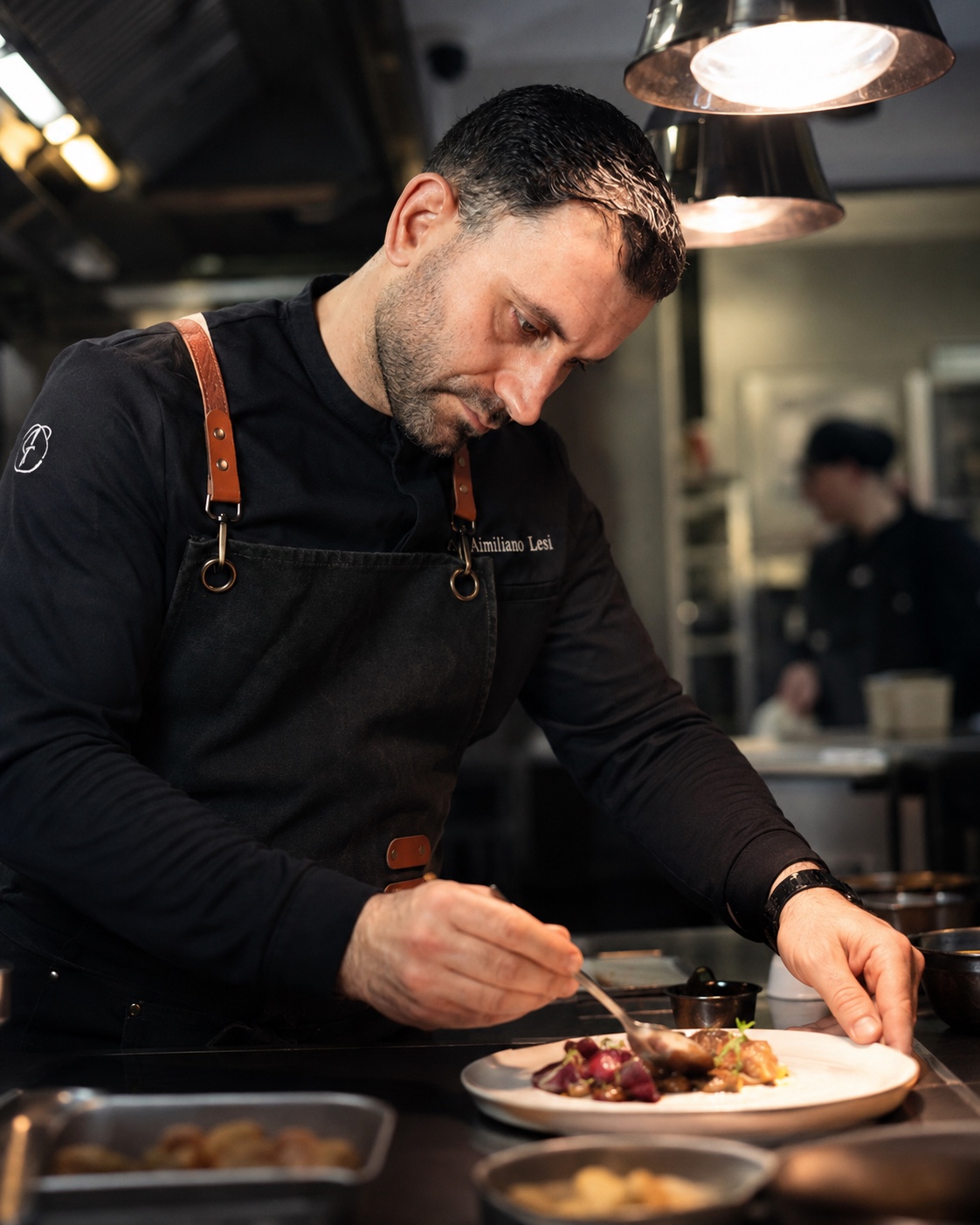 Chef Aimiliano Lesi plating during service