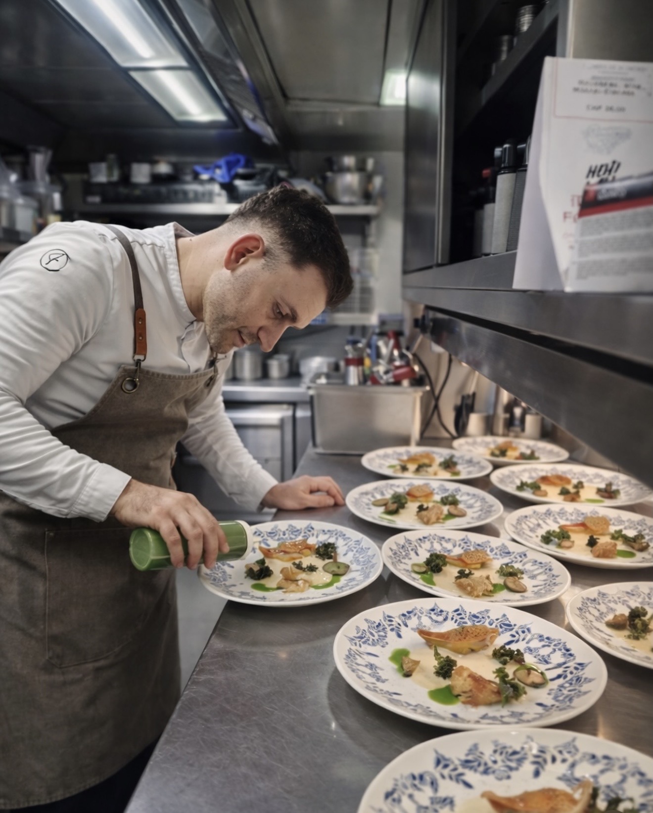 Chef Aimiliano Lesi finishing plates during service